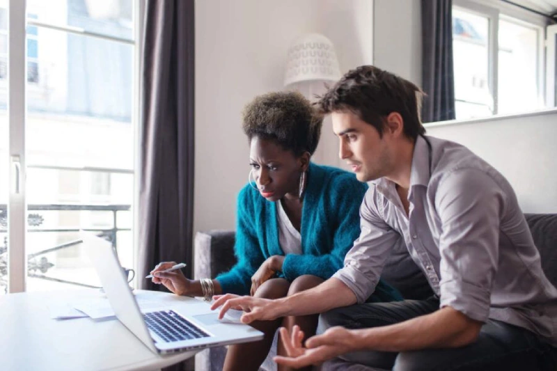 man-and-woman-seated-next-to-each-other-looking-at-laptop-screen-900x600.jpg.optimal