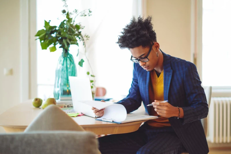 man-reviewing-paperwork-on-clipboard